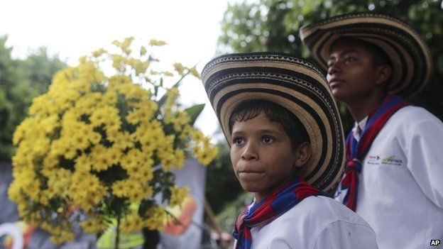 Boys from a music band attend a symbolic funeral in Aracataca, Monday, April 21, 2014