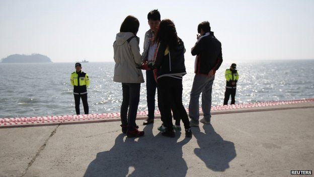 Family members of missing passengers who were on the ferry wait for news of their loved ones at Jindo