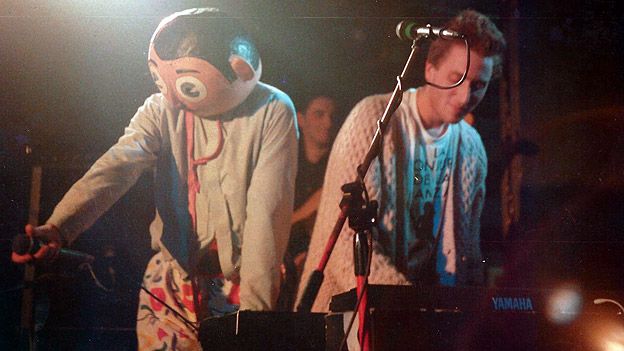 Frank Sidebottom on stage with Jon Ronson