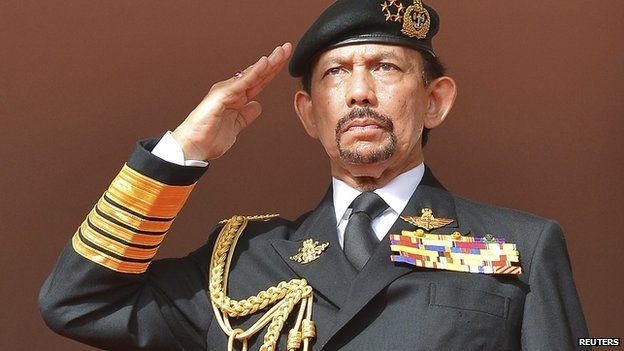 Brunei's Sultan Hassanal Bolkiah salutes as the national anthem is played during celebrations for Brunei"s 30th National Day, in Bandar Seri Begawan on 23 February, 2014