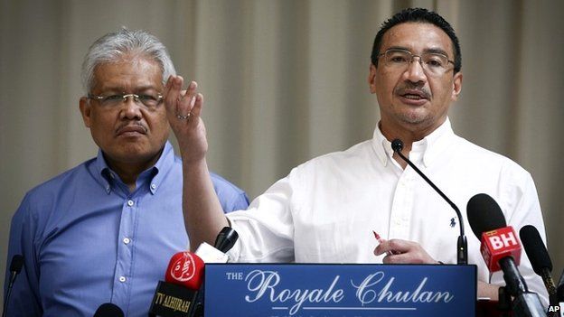 Malaysian Deputy Minister of Foreign Affairs Hamzah Zainudin, left, listens as Malaysia's acting Transport Minister Hishammuddin Hussein talks during a press conference in Kuala Lumpur - 19 April 2014