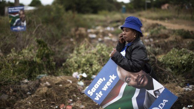 A supporter of the leader of South African opposition Democratic Alliance (DA) which one of their posters - 16 April 2014