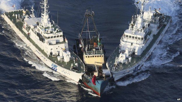 The Boa Diao boat (C) is surrounded by Japan Coast Guard patrol boats after Hong Kong activists descended from the boat onto Uotsuri Island, one of the East China Sea islands, on 15 August 2012