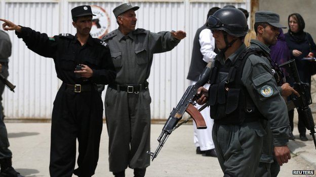 Afghan police outside the Cure hospital in the aftermath of the attack