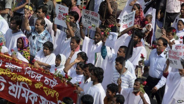 Bangladeshi activists and relatives of the victims of the Rana Plaza building collapse wear funeral shrouds as they take part in a protest marking the first anniversary of the disaster at the site where the building once stood in Savar on the outskirts of Dhaka on April 24, 2014