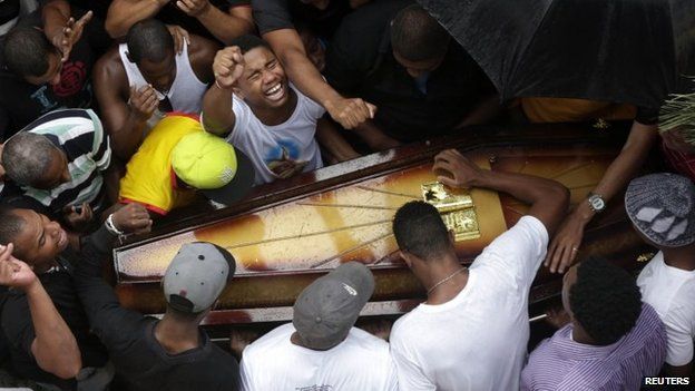 Relatives and friends of Douglas Rafael da Silva Pereira mourn during his burial in Rio de Janeiro, April 24, 2014.
