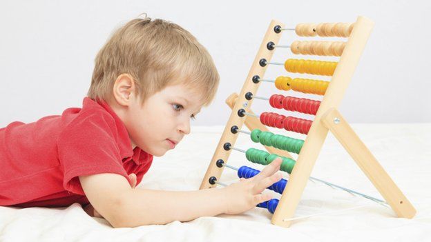 Child playing with abacus