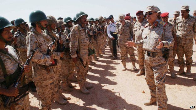 Yemeni Defence Minister Mohammad Nasser Ahmad, right, talks to troops at a military site in the southern province of Shabwa, Yemen, 28 April 2014