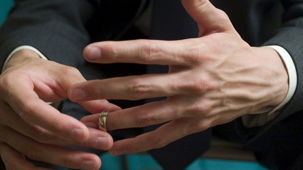 Man removing wedding ring
