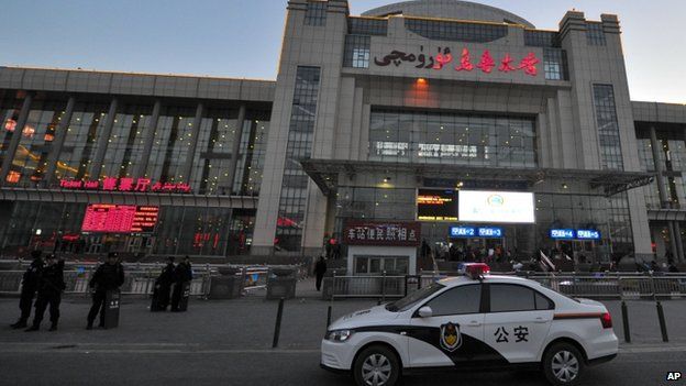 Chinese police men guard the entrance to the Urumqi South Railway Station in Urumqi in northwest China's Xinjiang Uighur Autonomous Region 30 April 2014