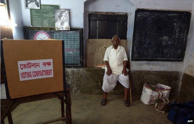 An Indian voter waits to cast his ballot as the Electronic Voting Machine (EVM) stopped working at a polling station in the village in West Bengal on 30 April 2014