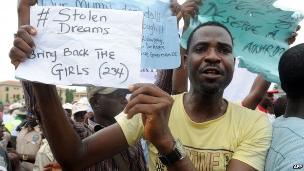 A man carries placard to campaign for the release of schoolgirls kidnapped by Boko Haram Islamists more than two weeks ago during worker's rally in Lagos on 1 May 2014