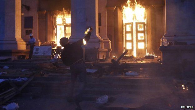 A protester throws a petrol bomb at the trade union building in Odessa on 2 May 2014