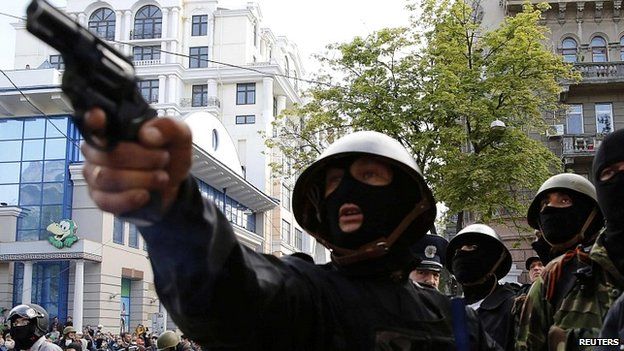 A pro-Russian aims a pistol at supporters of the Kiev government during clashes in Odessa - 2 May 2014