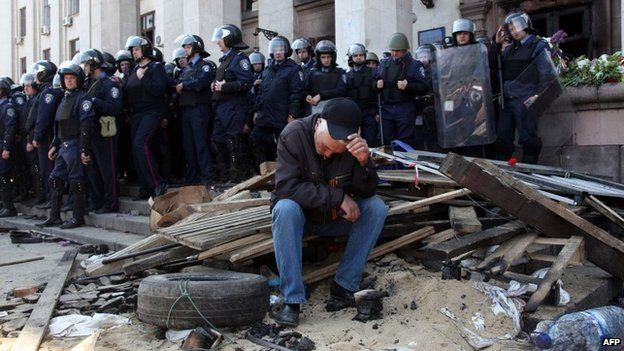 Pro-Russian activist sits in front of the burned out trade union building in Odessa, 3 May 2014