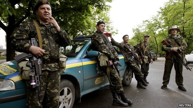 Pro-Russian gunmen stand near the seized regional government headquarters in Luhansk - 3 May 2014