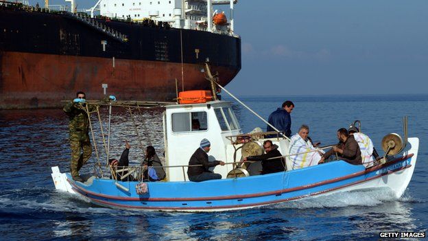 Immigrants arrive at the port of Chania on the island of Crete on 1 April 2014