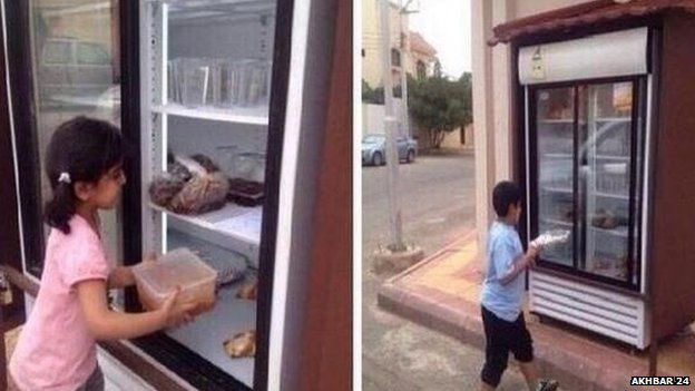 Children put food in Saudi charity fridge