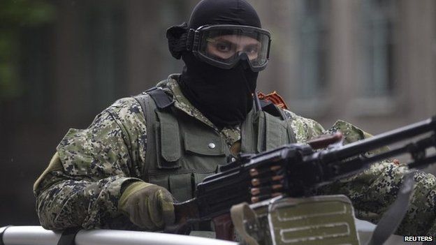 Pro-Russian armed man rides in a car in Sloviansk, 8 May