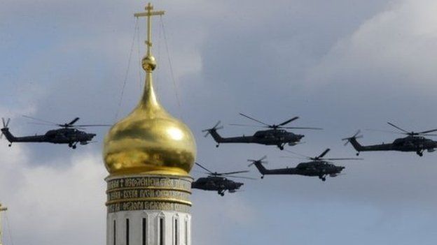 Military helicopters fly in formation during rehearsals for the Victory Day military parade