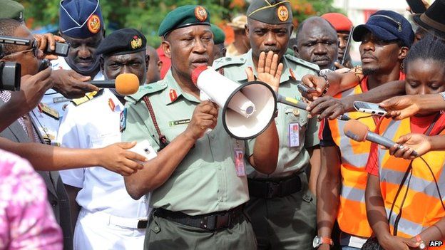 Defence spokeman Major General Chris Olukolade speaks to a crowd in Abuja protesting over the government's "indifference" to the mass abduction - 6 May 2014