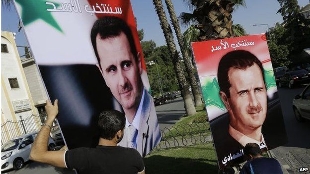 Workers erect pro-Assad campaign billboards in Damascus (11/05/14)
