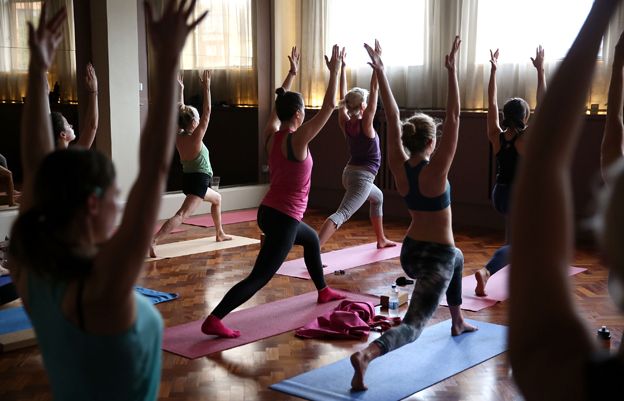 A yoga class with people in a lunge pose