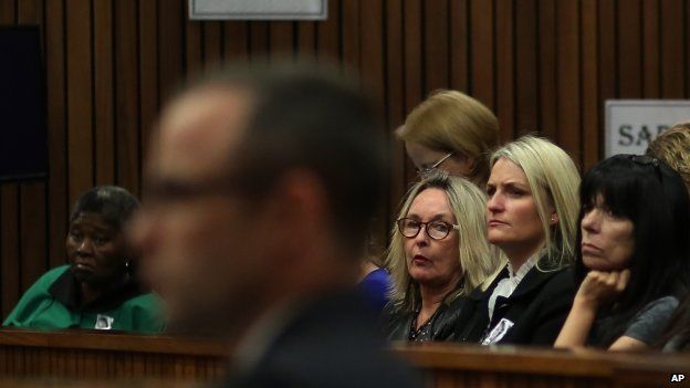 June Steenkamp, the mother of Reeva Steenkamp, (third from right) looks at Oscar Pistorius (foreground in the dock) on 13 May 2014