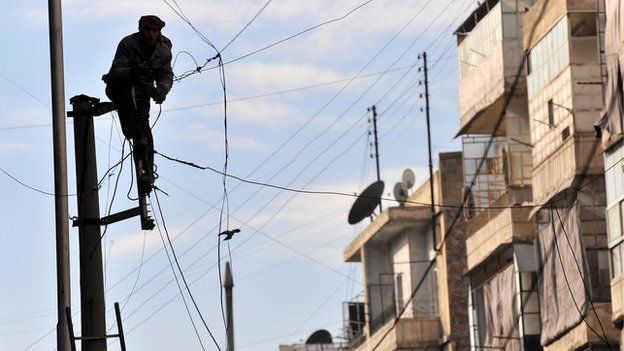 Man fixing electricity in Aleppo (file photo)