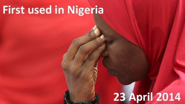 TEXT: First used in Nigeria, 23 April 2014 IMAGE: A woman with her head bowed at a rally for he missing girls in Nigeria