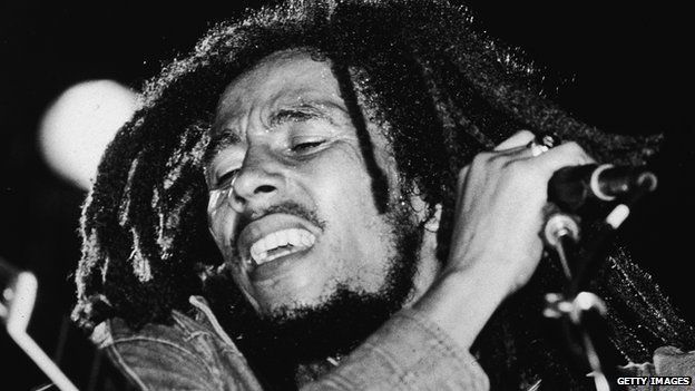 Jamaican reggae musician Bob Marley (1945 - 1981) performs on stage, a microphone in his hand, late 1970s.