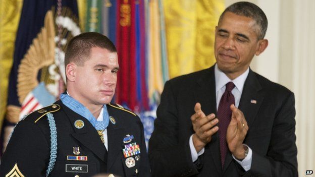 President Barack Obama (right) applauds after awarding the Medal of Honour to former Army Sergeant Kyle White in Washington on 13 May 2014