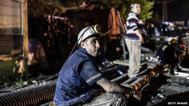 A miner sits outside a mine in Soma after a deadly explosion