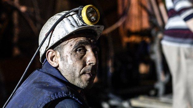 A miner sits outside a mine in Soma after a deadly explosion