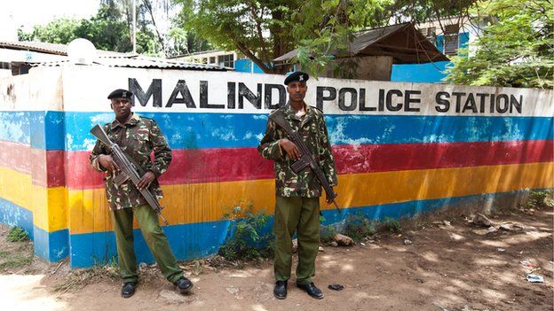 Two officers stand guard outside the Malindi police station in Kenya on 28 March 2013