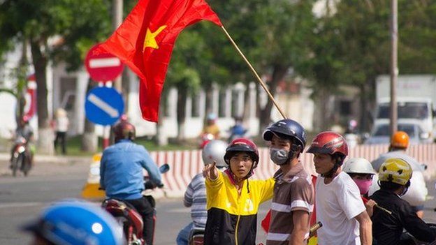 Protesters stand on the corner of a street in Quan Doan 4, Binh Duong province, near Song Than 2 Industrial Park in Vietnam, on 14 May.