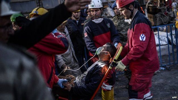 Rescuers evacuate a colleague after inhaling smoke at a mine in Soma, Turkey, on 15 May 2014