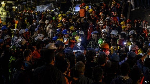 Rescuers and miners are seen as they carry out dead miners on 15 May 2014