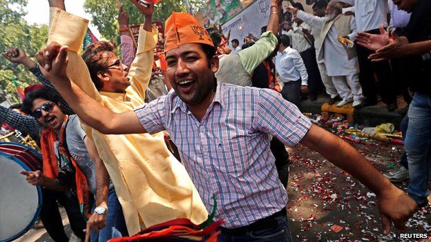 BJP supporters celebrate outside the party's headquarters in New Delhi on 16 May 2014