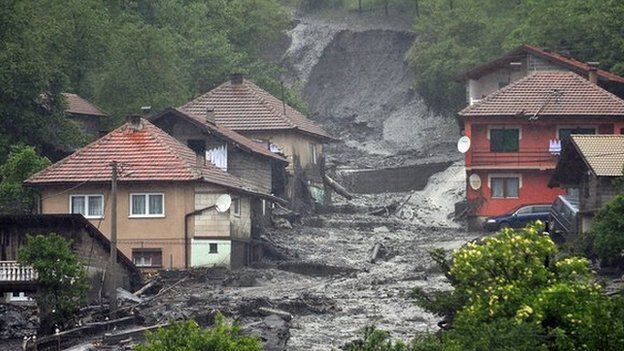 A view of a landslide and floodwaters around houses in the village of Topcic Polje, near the central Bosnian town of Zenica, on 15 May 2014
