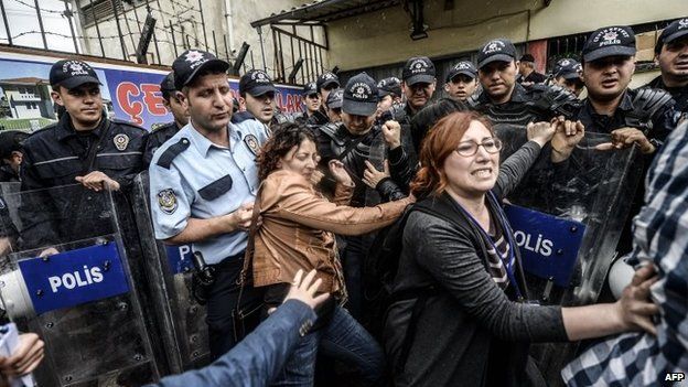 Two women push against riot police in Soma, Turkey, 17 May 2014