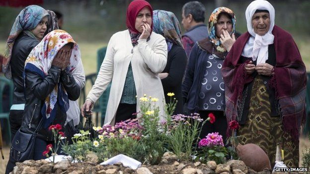 Friends and relatives of the miners who died in an explosion at the Soma mine pray in Soma cemetery following the burial of further bodies recovered from the mine in Soma, Turkey, 17 May 2014