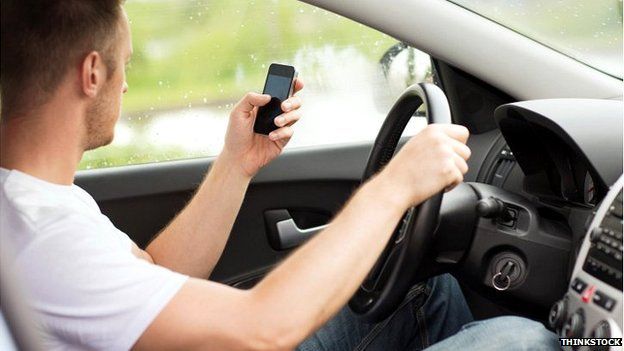 Man using phone while driving the car