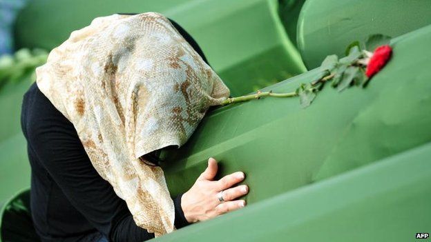 Survivor of 1995 massacre mourns a relative at memorial cemetery in Srebrenica