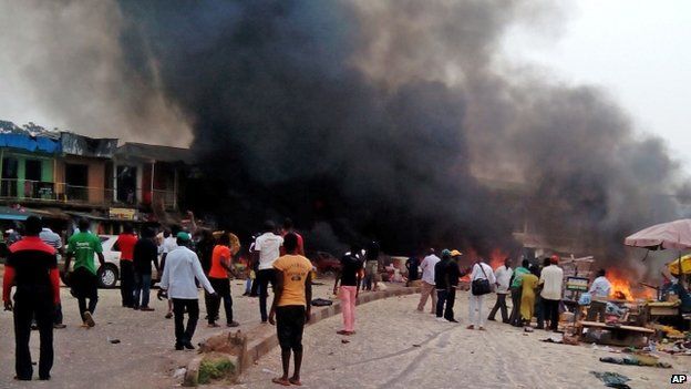 Smoke rises after a bomb blast at a bus terminal in Jos, Nigeria (20 May 2014)