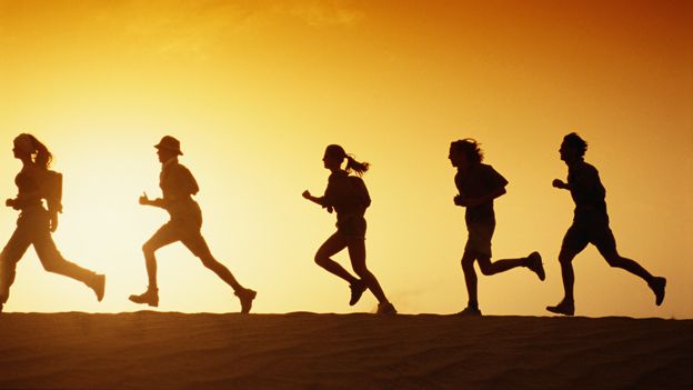 Runners in profile in the desert