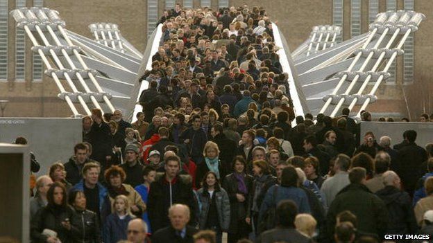 File photo: Thousands of people cross the Millennium Bridge for the first time after it reopens, 22 February 2002