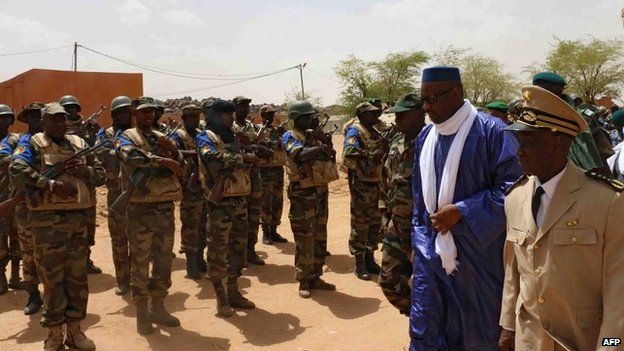 Mali's Prime Minister Moussa Mara reviews troops upon his arrival at Kidal, northern Mali, on May 17, 2014,