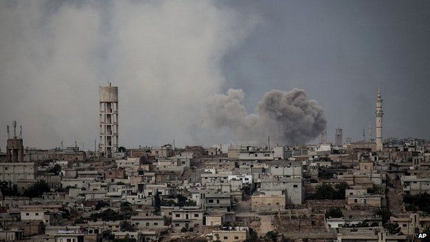 Smoke rises after a bomb was dropped by government forces from a helicopter above a village in Idlib province - 19 September 2013
