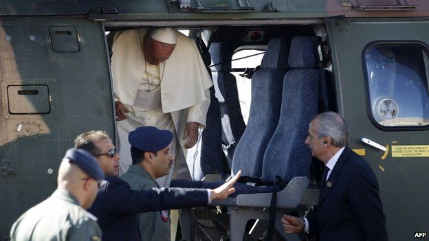 Pope Francis disembarks a Jordanian military helicopter